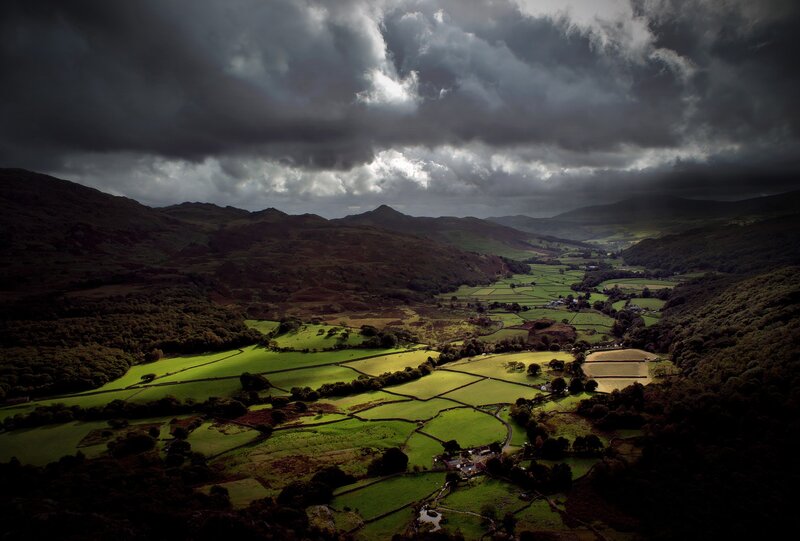 dramatic valley under stormy sky