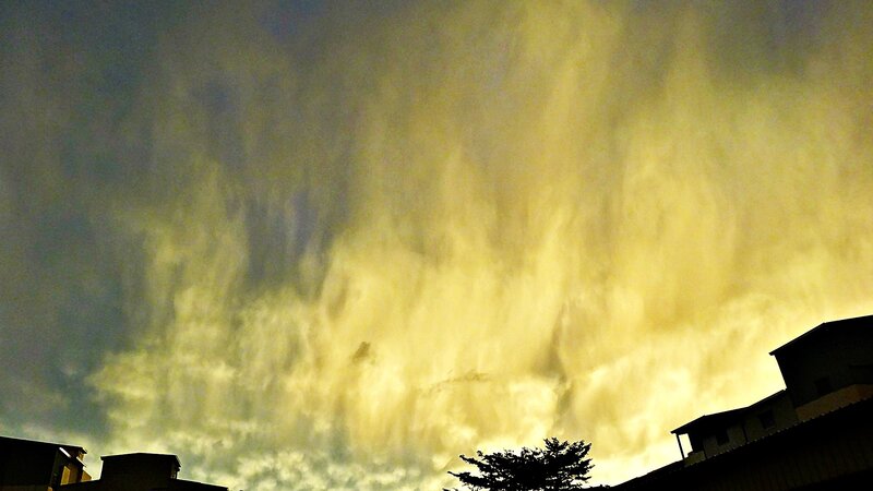 dramatic yellow sky over buildings