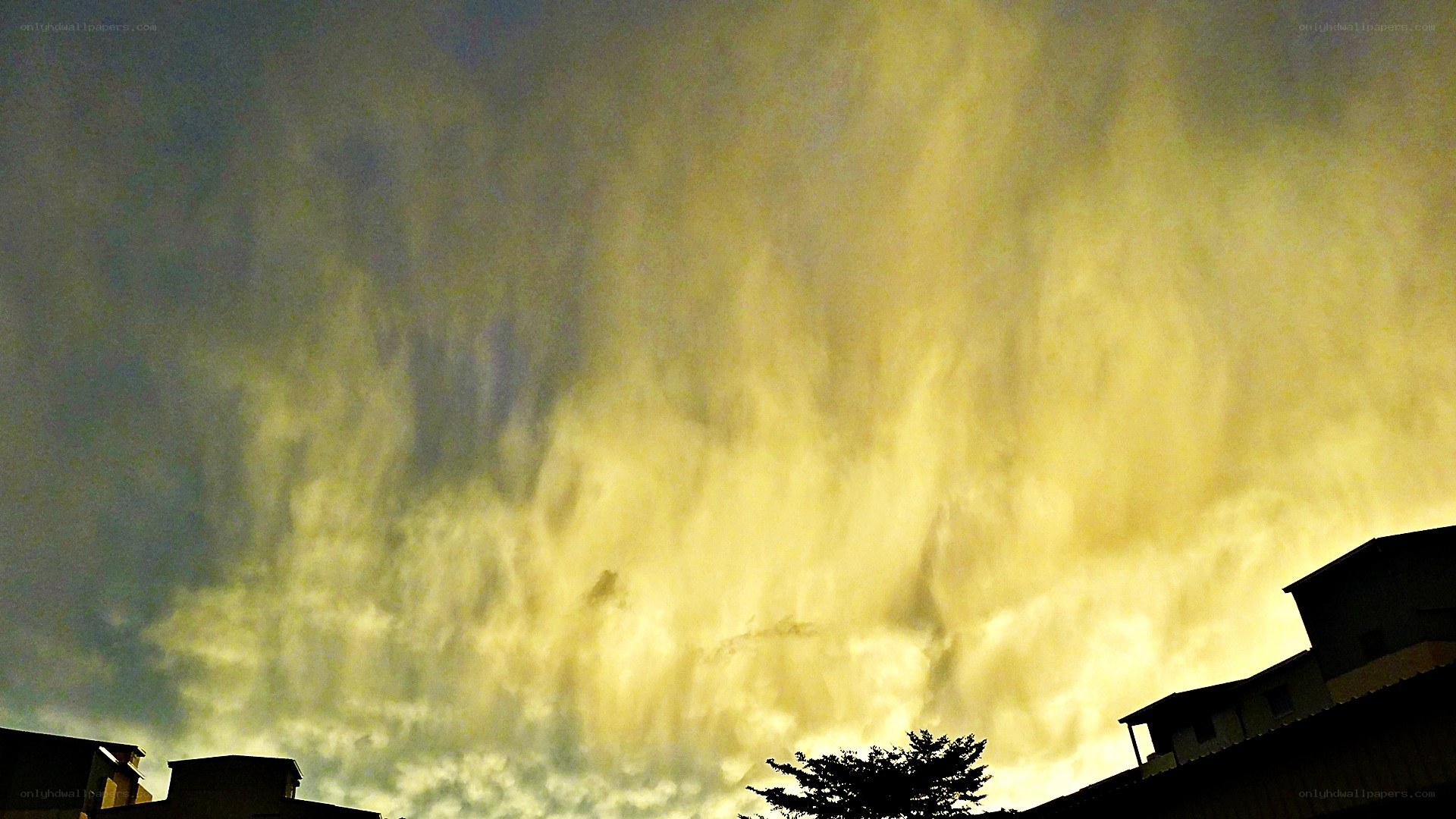 dramatic yellow sky over buildings