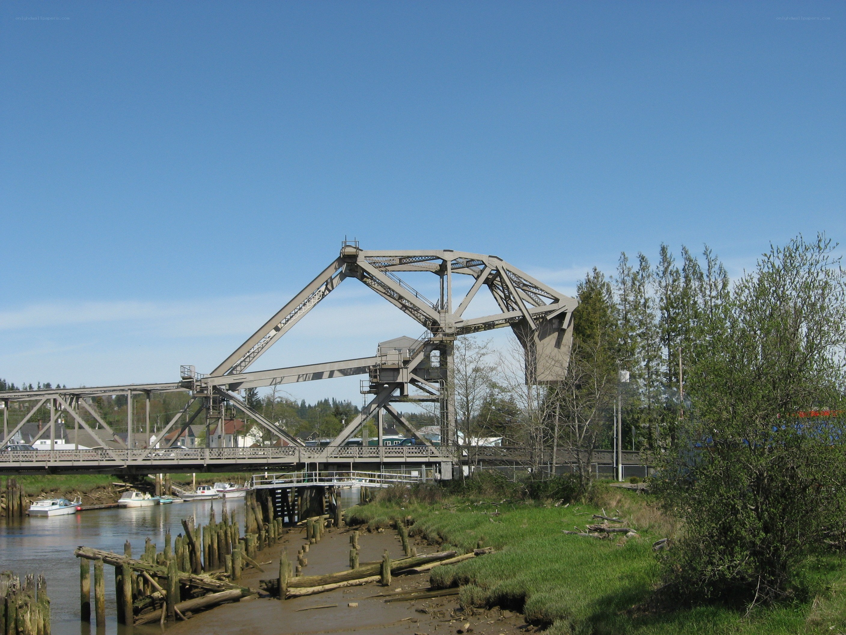 drawbridge over river on sunny day