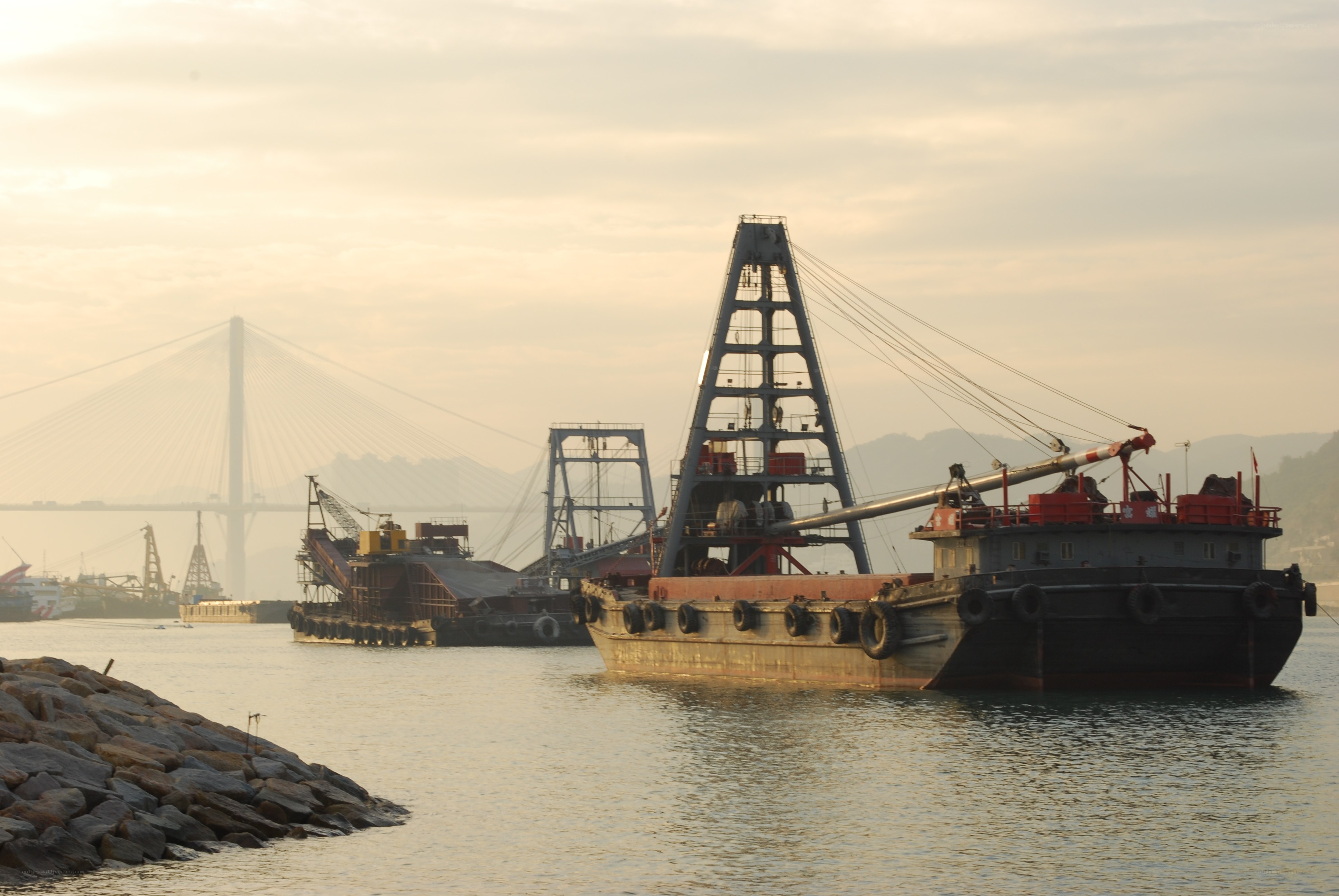 Dredging boats near a bridge