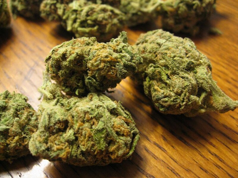dried cannabis buds on wood
