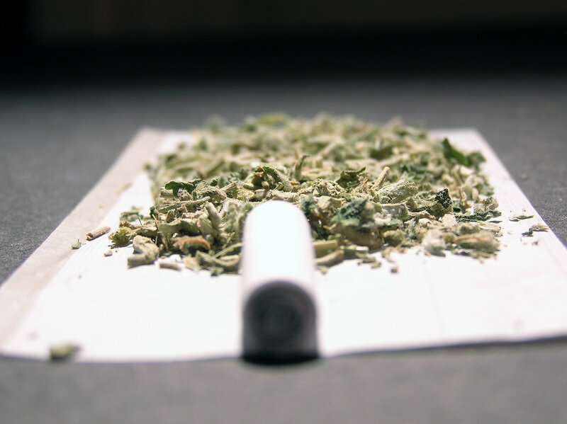 dried herbs on a rolling paper