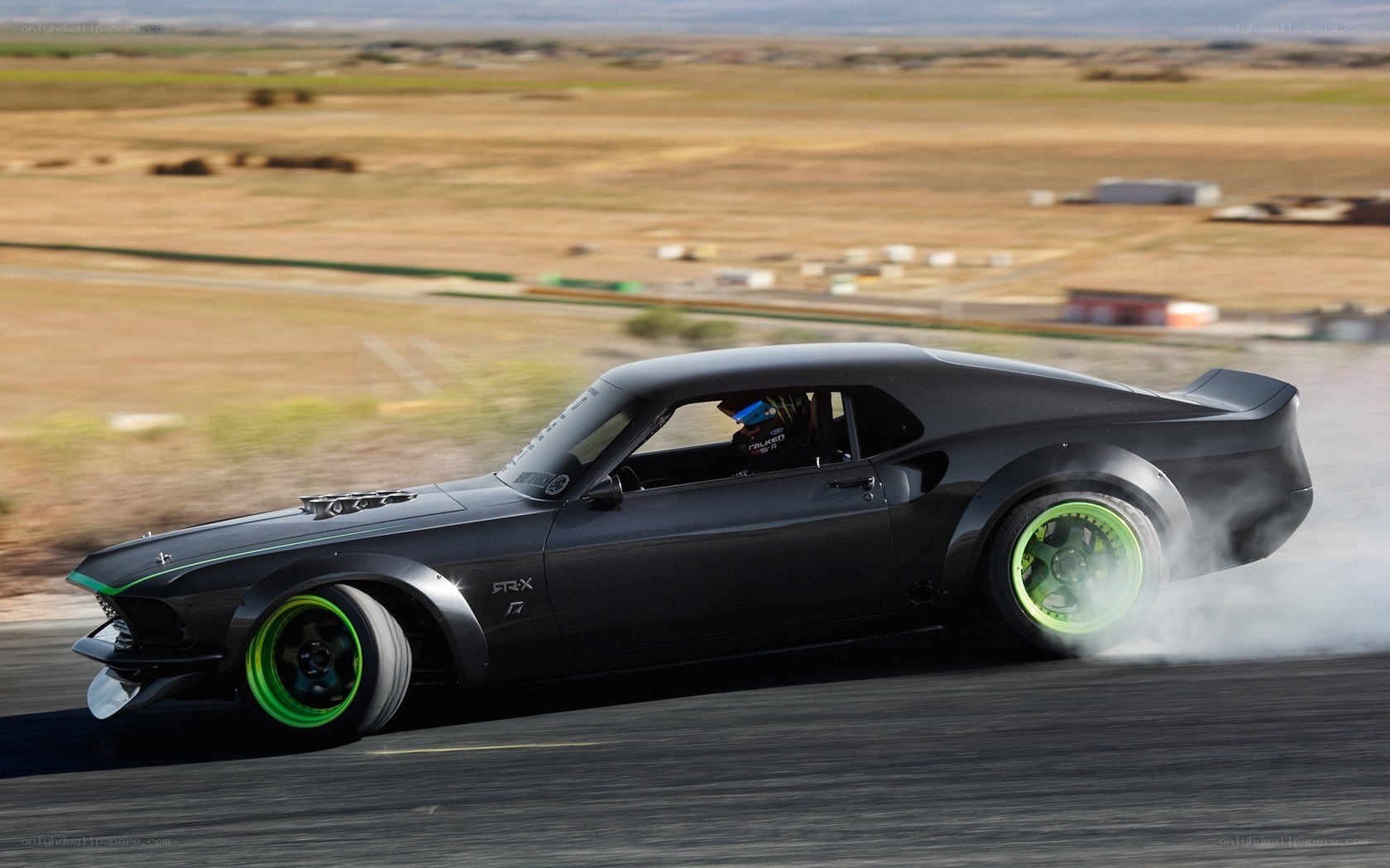 drifting black muscle car