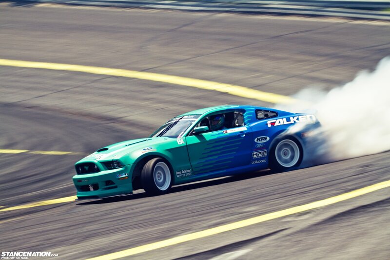 Drifting green and blue Ford Mustang