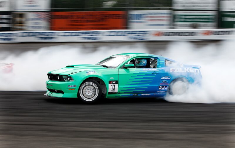 Drifting green and blue Ford Mustang