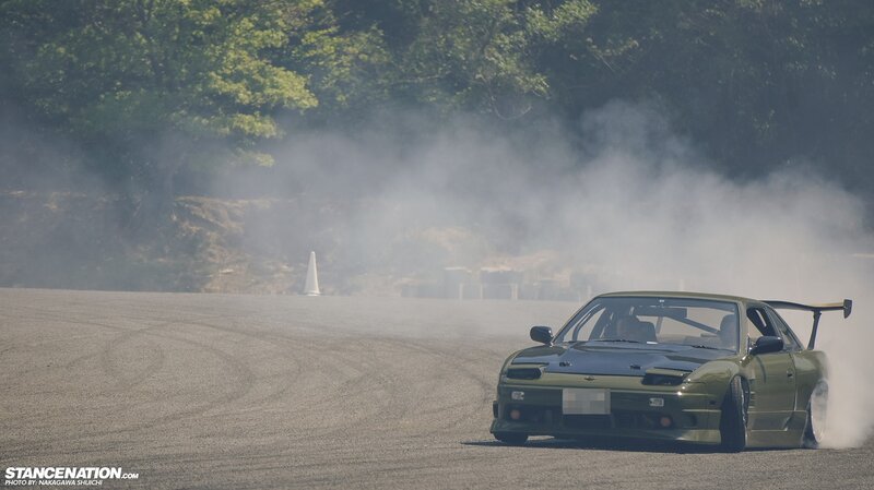 Drifting green car on track
