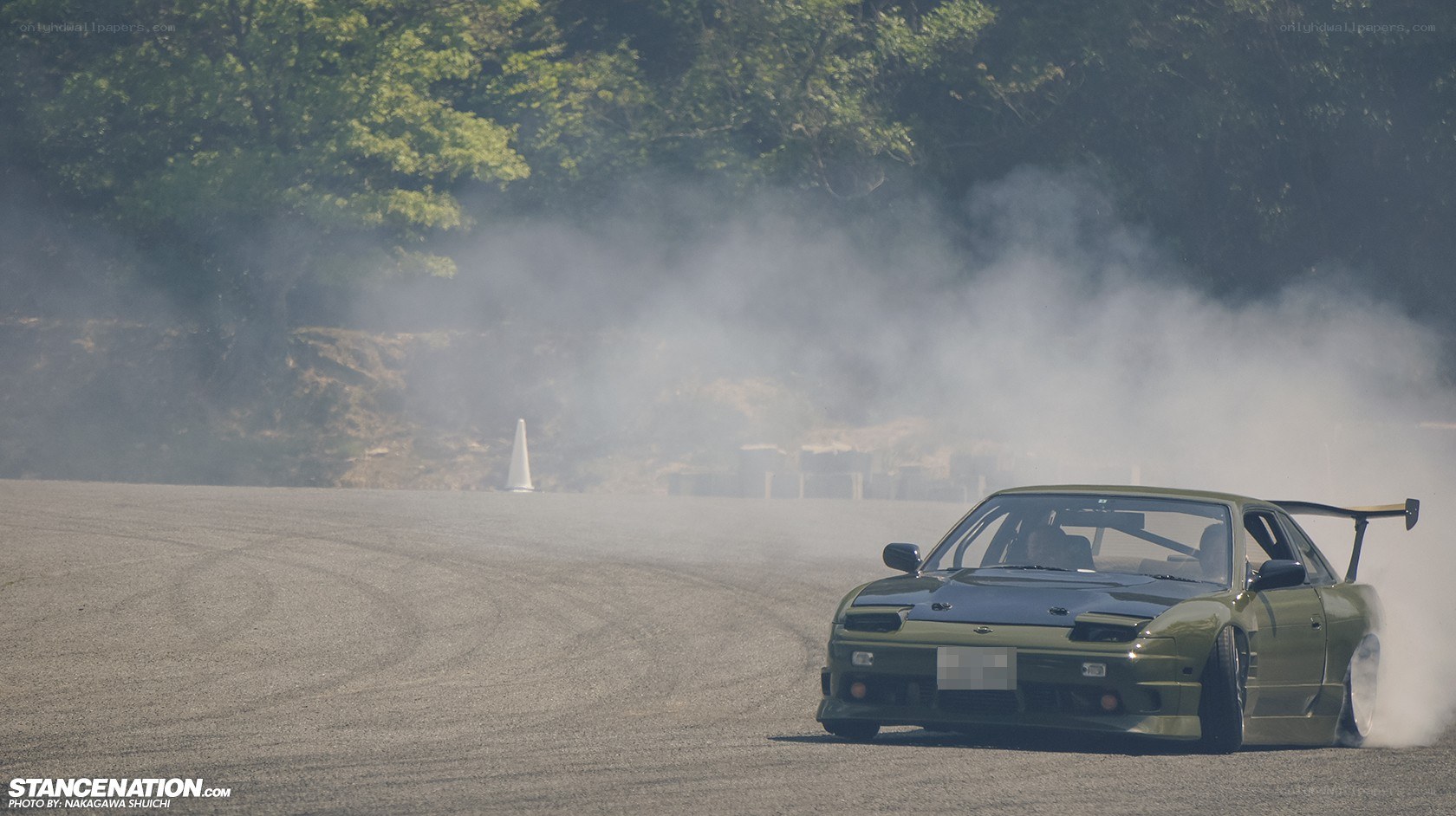 Drifting green car on track