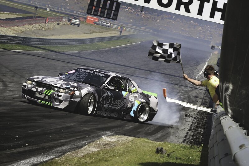Drifting Race Car — Black, Dynamic, Afternoon, Photograph, Checkered Flag