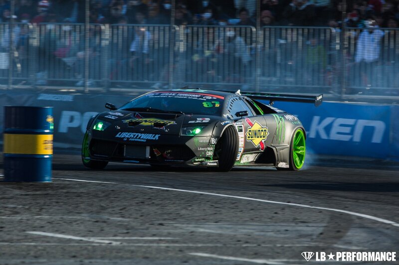 Drifting Race Car — Black, Dynamic, Afternoon, Photograph, Crowd