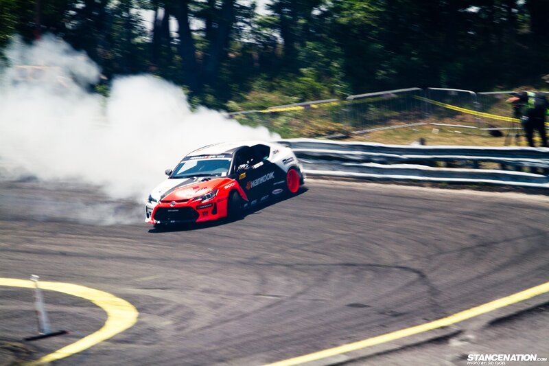 Drifting Race Car — Black, Dynamic, Afternoon, Photograph, Smoke, Racetrack, Guardrail, White