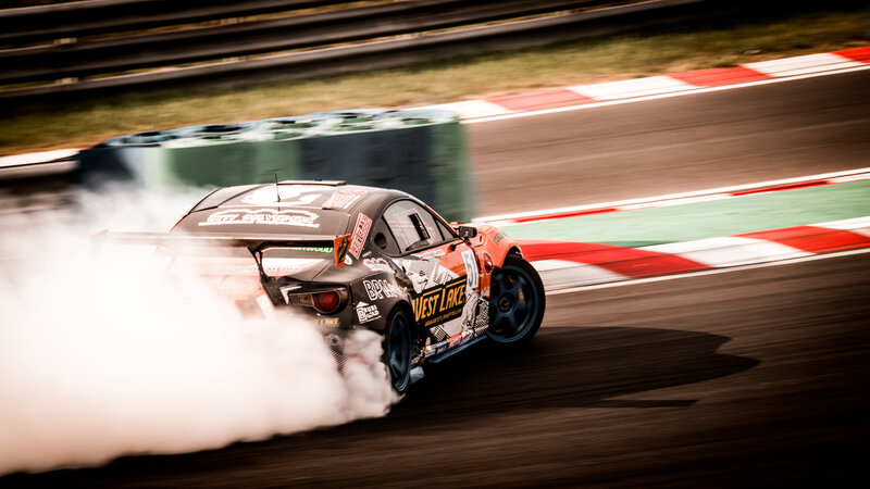 Drifting Race Car — Black, Dynamic, Afternoon, Photograph, Smoke, Racetrack, Tire Marks