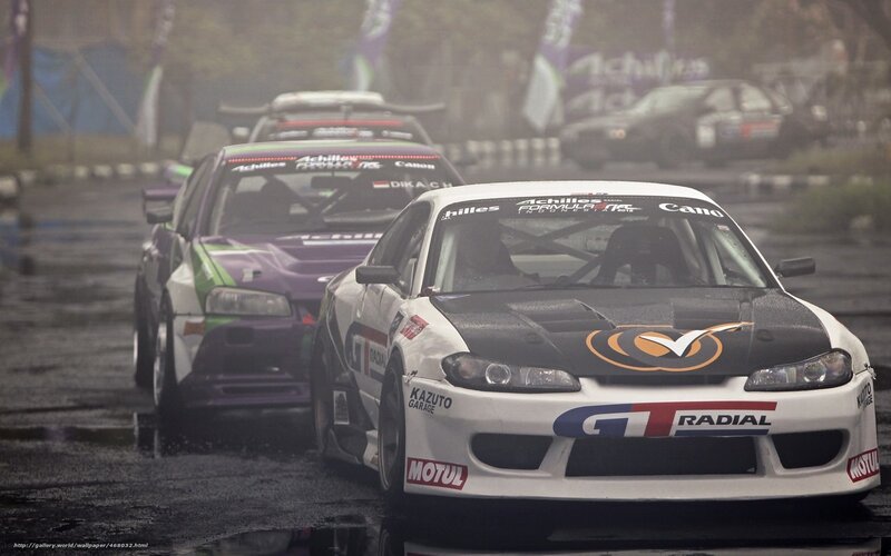 Drifting race cars on wet track