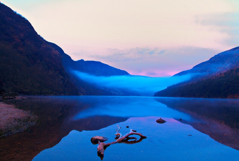 Driftwood in Lake — Blue, Serene, Sunset, Photograph, Mountains
