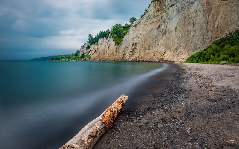 Driftwood on Beach — Blue, Dramatic, Photograph, Cliff, Ocean