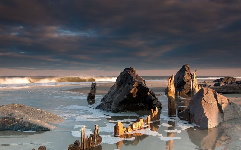 Driftwood on Beach — Gray, Dramatic, Sunset, Photograph, Rocks, Ocean, Clouds, Waves