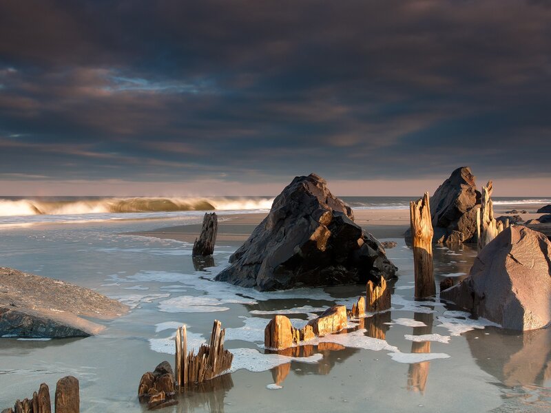 Driftwood on Beach — Gray, Dramatic, Sunset, Photograph, Rocks, Ocean, Sky, Waves