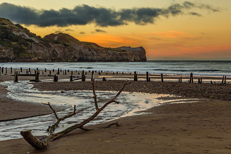 Driftwood on Beach — Orange, Dramatic, Sunset, Photograph, Cliffs