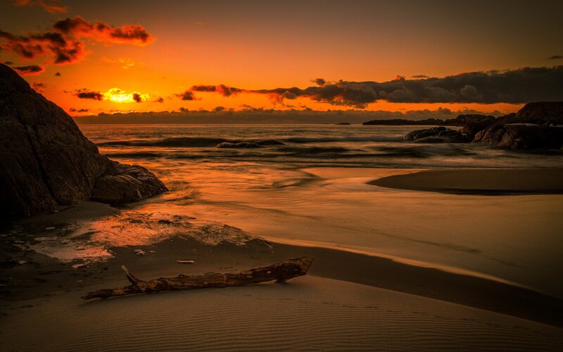 Driftwood on Beach — Orange, Dramatic, Sunset, Photograph, Rocks