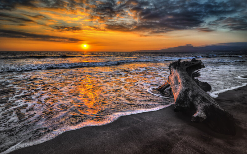 Driftwood on Beach — Orange, Dramatic, Sunset, Photograph, Sun, Ocean, Mountains