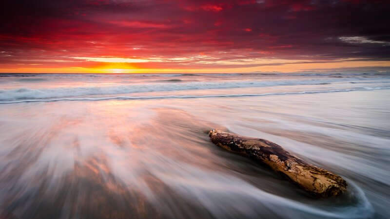Driftwood on Beach — Red, Dramatic, Sunset, Photograph, Ocean, Sky, Waves