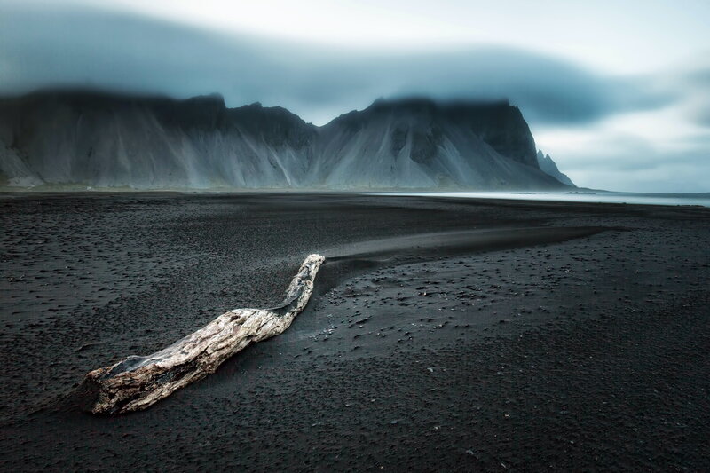 Driftwood on Black Sand — Dramatic, Photograph