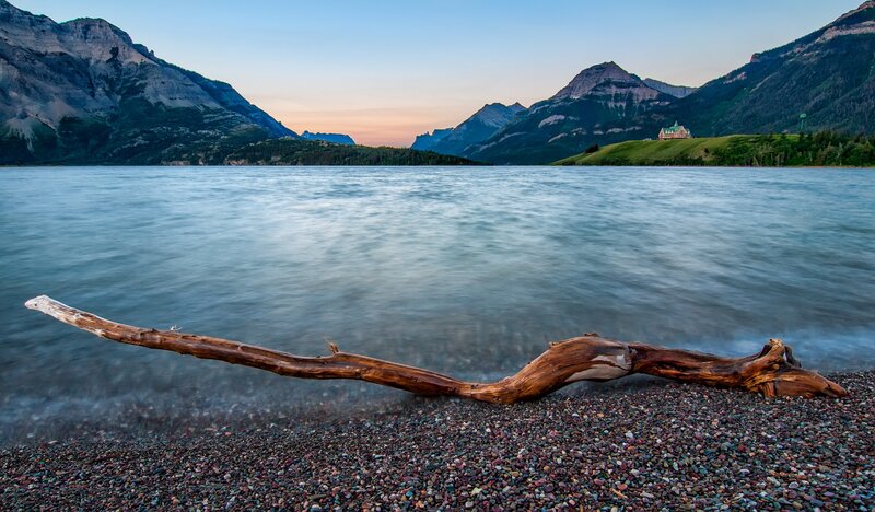 Driftwood on Pebble Beach — Blue, Serene, Sunset, Photograph, Lake