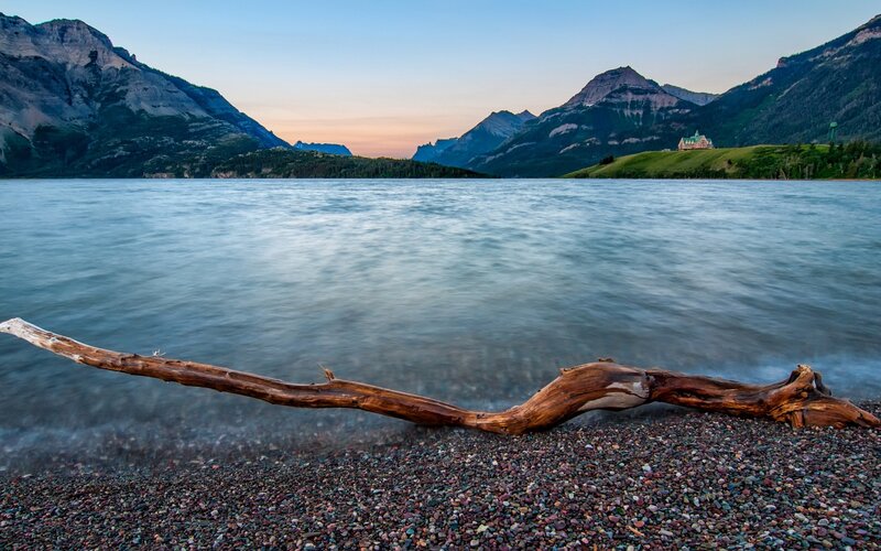 Driftwood on Pebble Beach — Blue, Serene, Sunset, Photograph