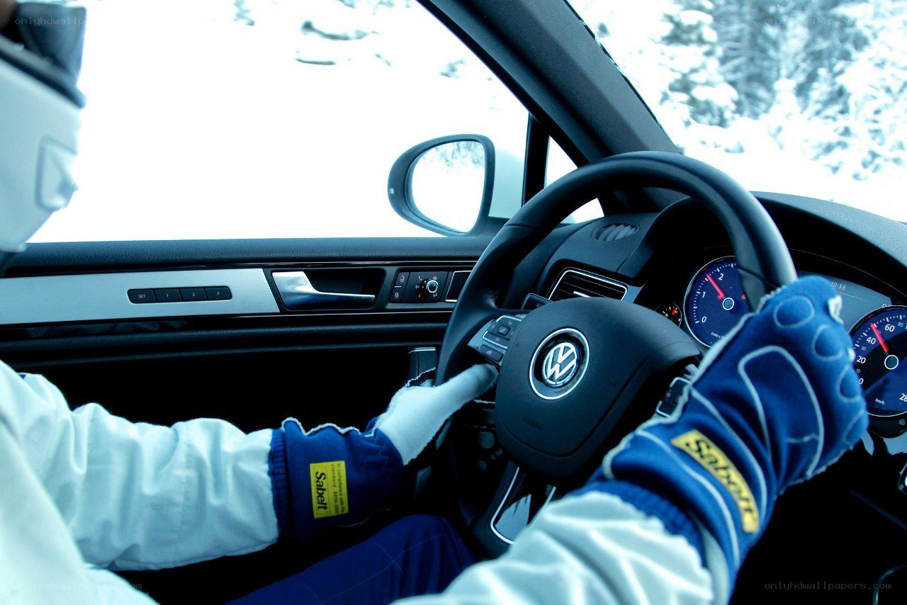 driver in racing gear inside car