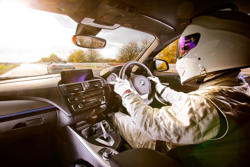 Driver in racing gear on track