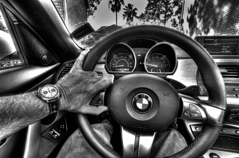 driver's hand on BMW steering wheel