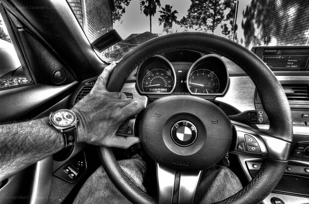 driver's hand on BMW steering wheel