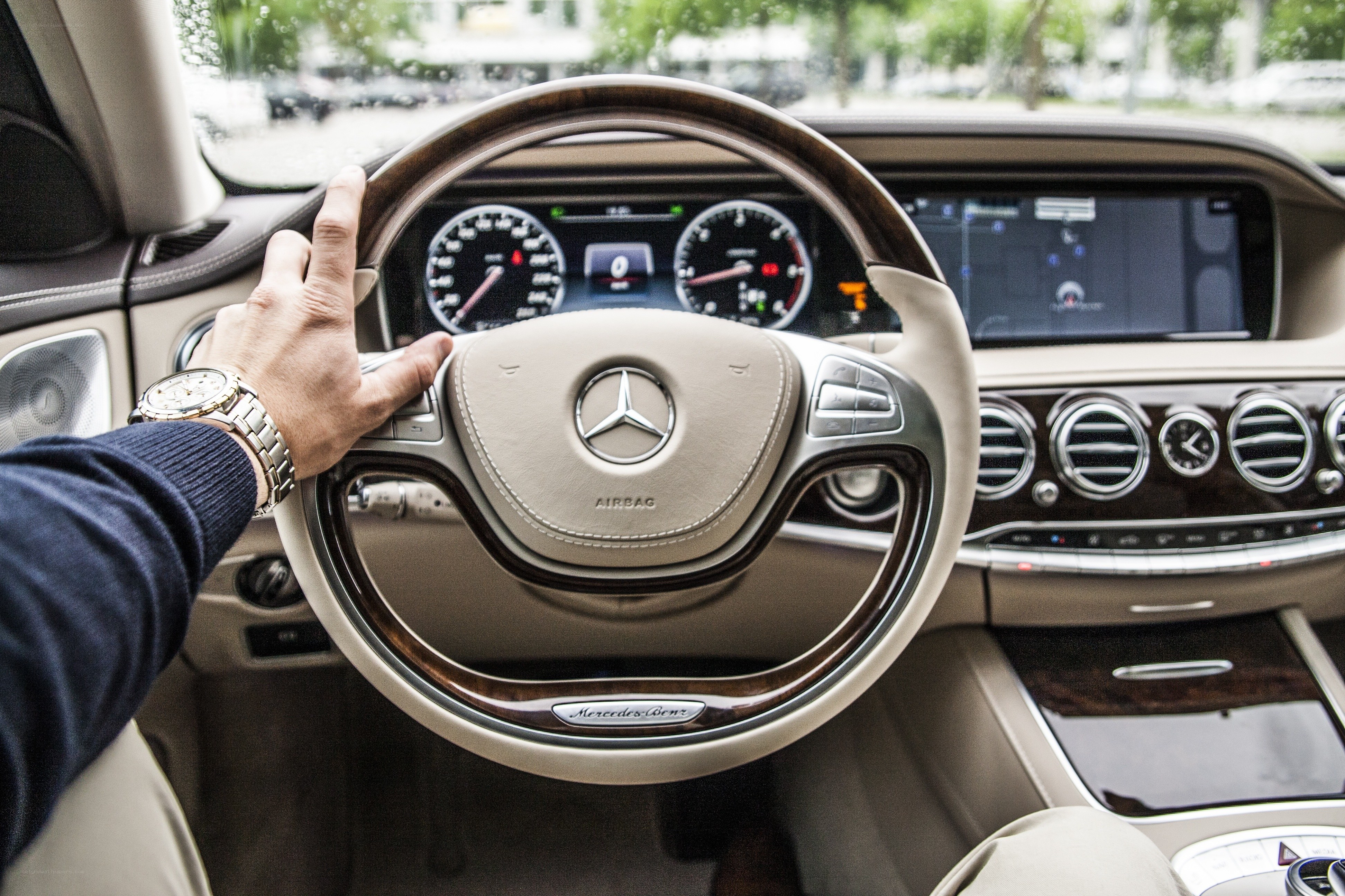 Driver's hand on Mercedes steering wheel