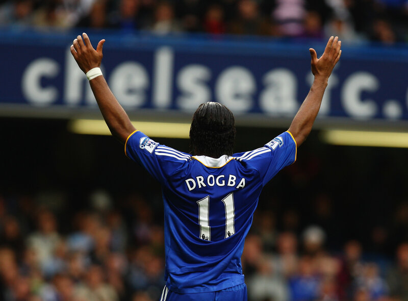 Drogba celebrates with arms raised