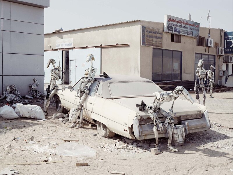 Droid Robots Around Car