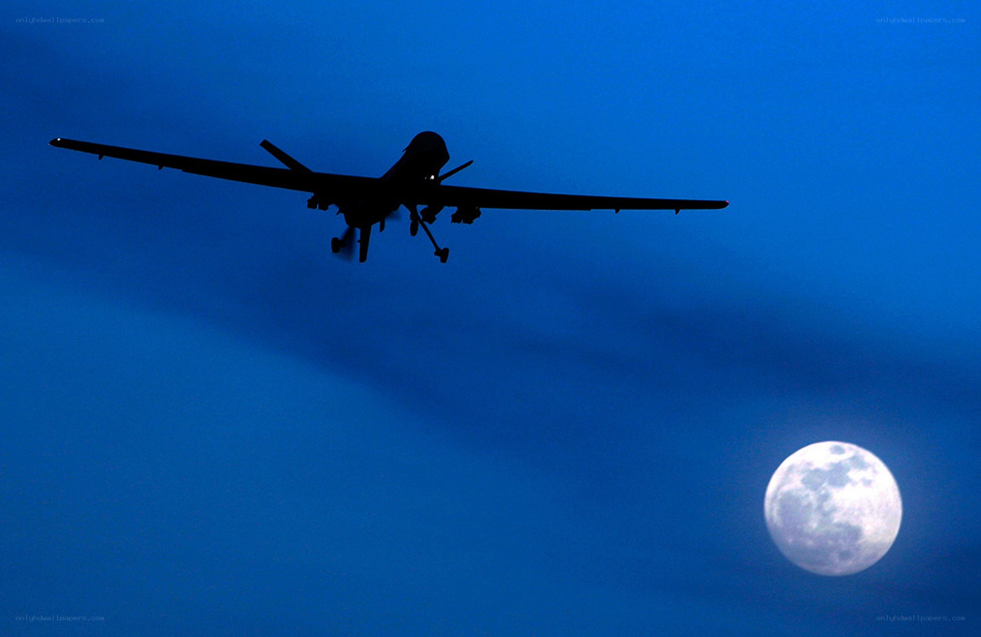 Drone silhouette against moon
