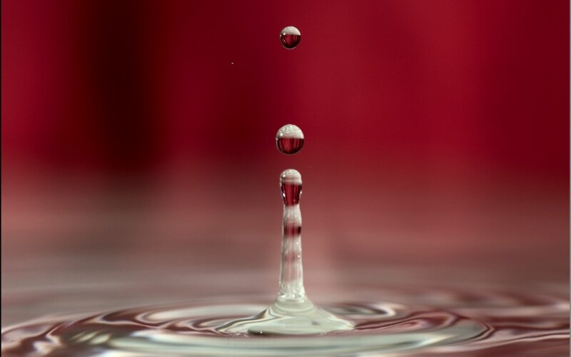Droplet Falling into Liquid — Red, Dramatic