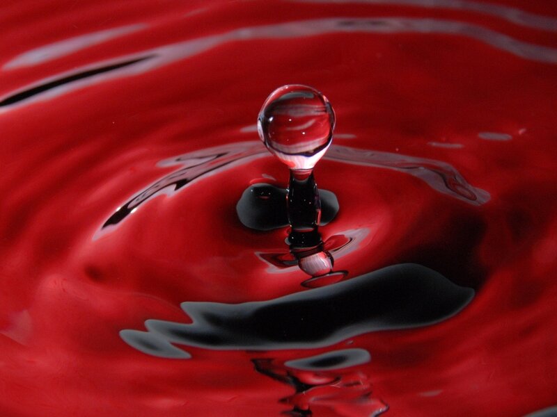 Droplet Falling into Red Liquid