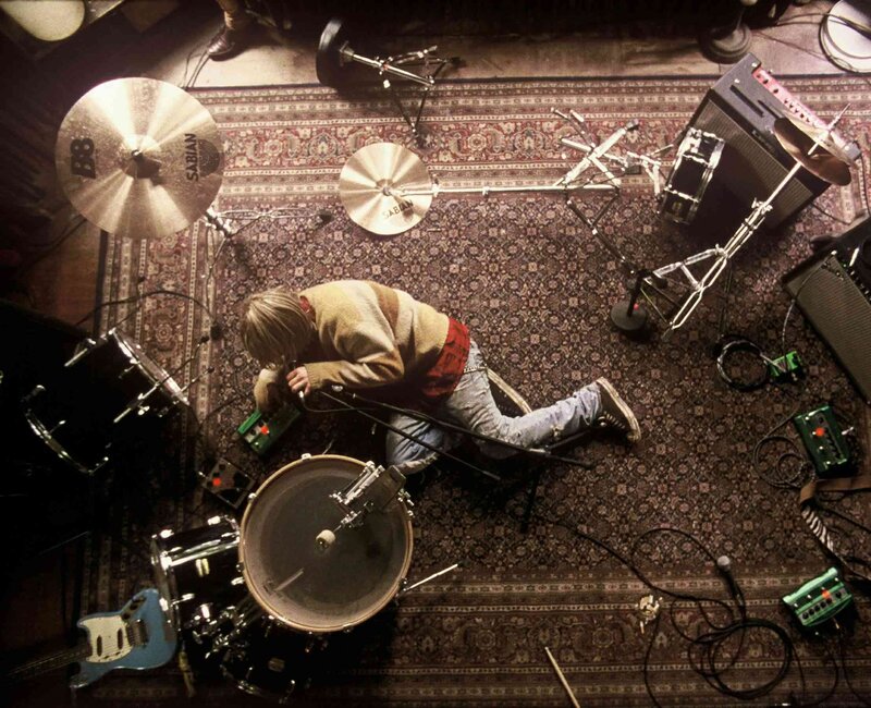 drummer adjusting equipment on stage