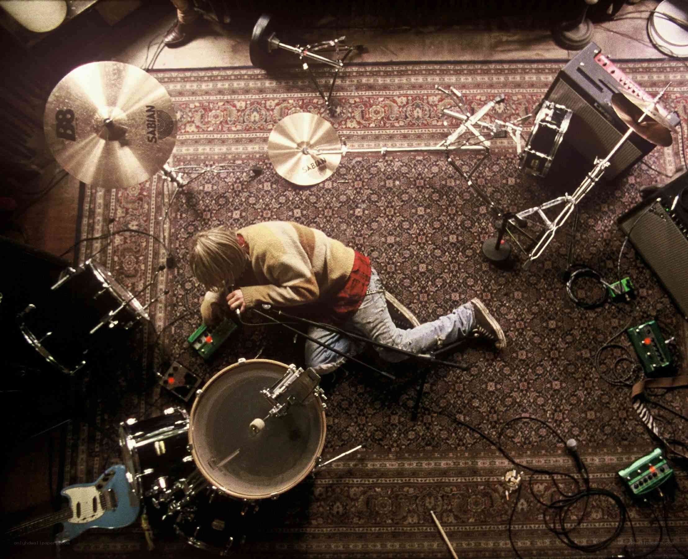 drummer adjusting equipment on stage