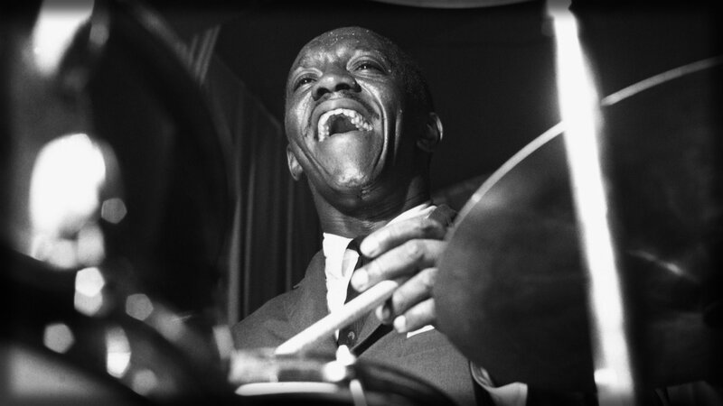 drummer laughing during performance
