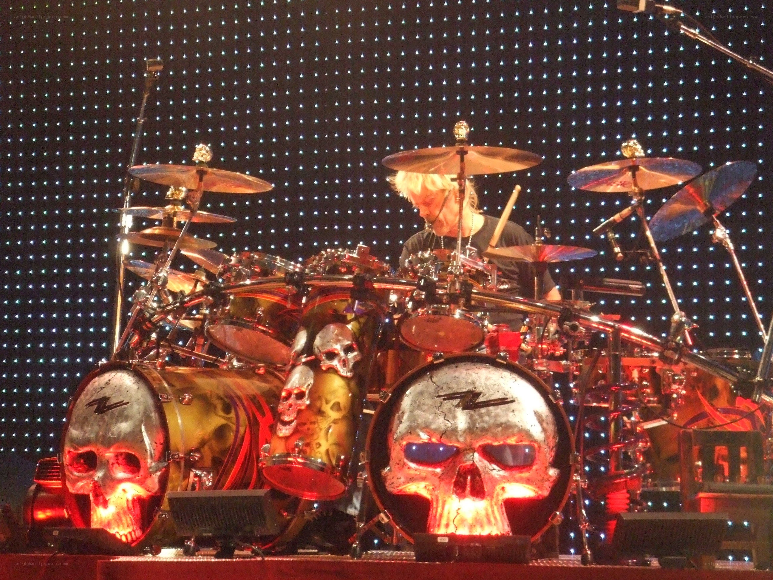 drummer with skull-themed drum kit