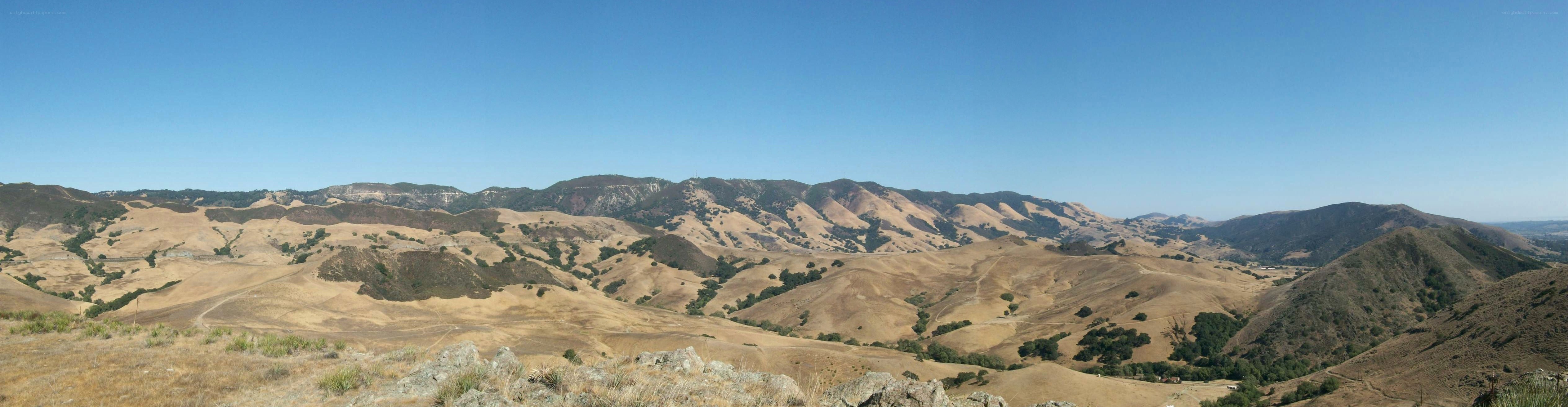 dry hills under blue sky