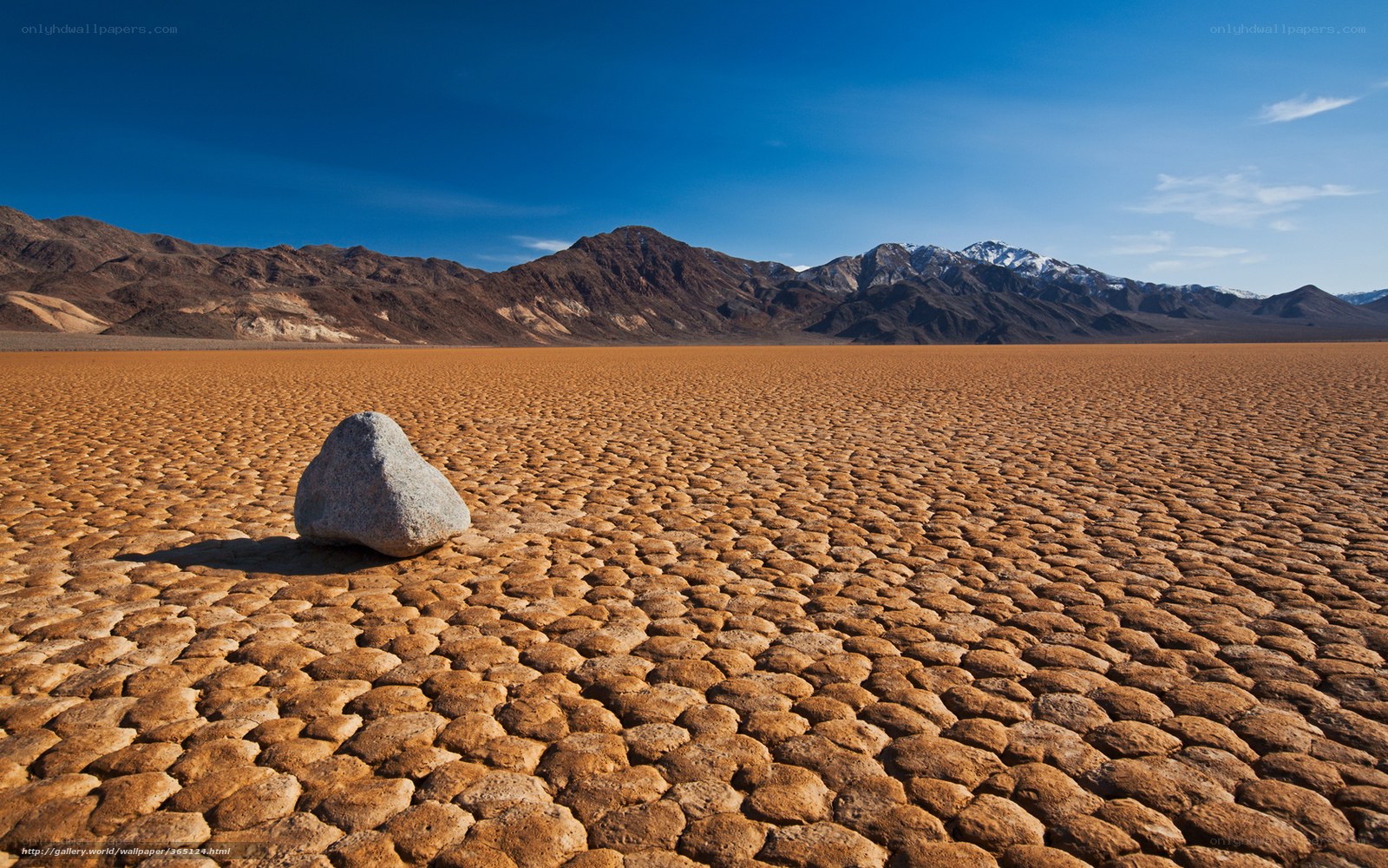 Dry lake bed with rock