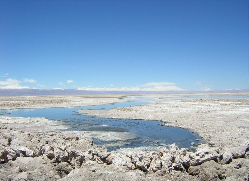 dry lake with snow-capped mountains