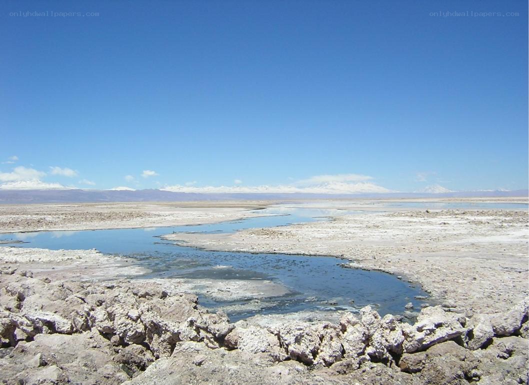 dry lake with snow-capped mountains