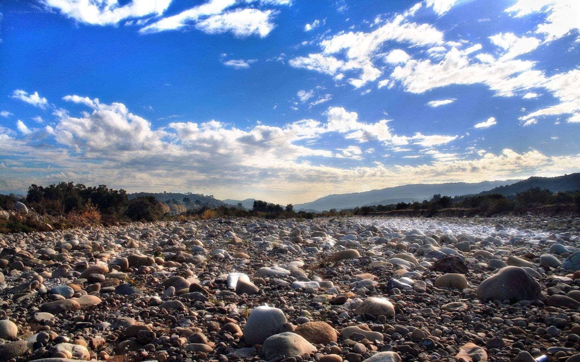 Dry riverbed under blue sky