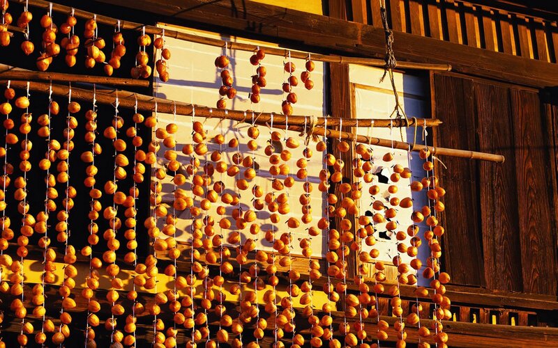 Drying persimmons on a wooden rack