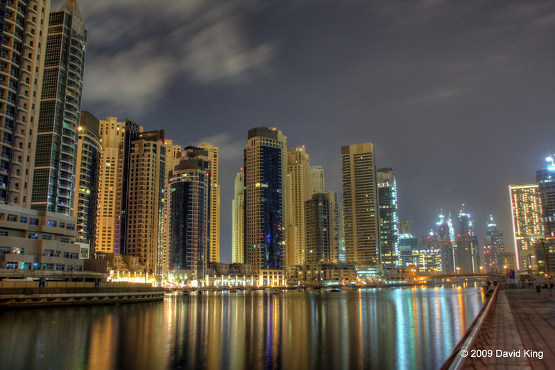 Dubai Skyline at Night — Black, Dramatic, Photograph, Skyscrapers, Water, Yellow