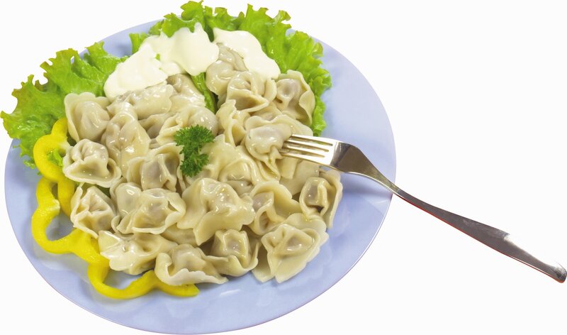 Dumplings with sour cream and lettuce